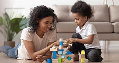 child and mom play with blocks