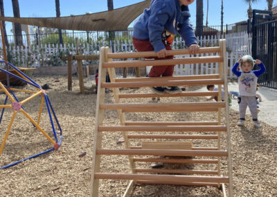 child climbing a playground ladder