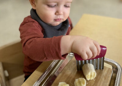 toddler cutting bananas