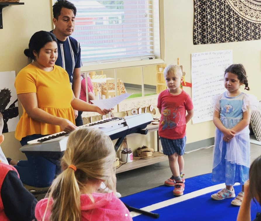 children stand as rachel teaches piano
