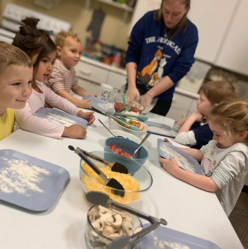 children make food in meal program class