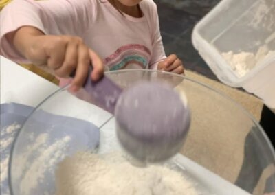 child scoops flour