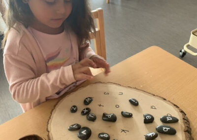 kindergarten student girl works on letter project