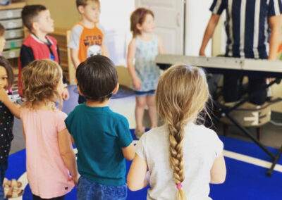children stand in circle in music class