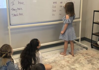 elementary student at board writing