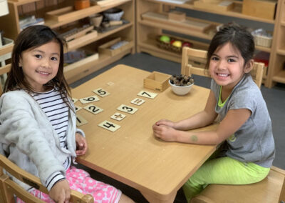 kindergarten student girls smile with flashcards