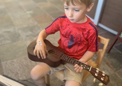 child learns ukulele