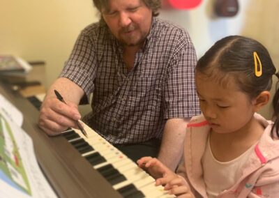 music teacher teaches piano