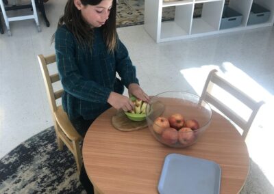child preps apple slices