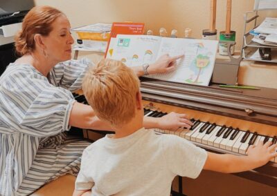 piano teacher teaches elementary student to read music