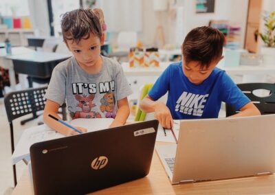 elementary students learn at laptop