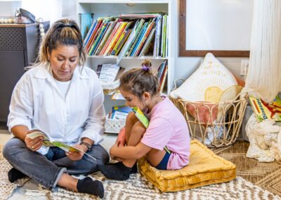 Teacher reading a book to a student