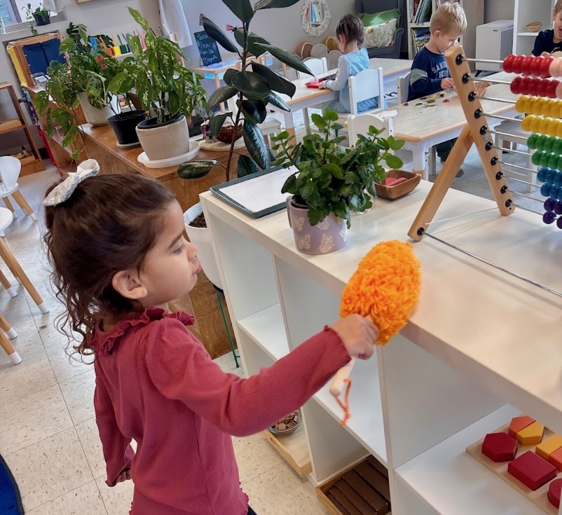 child thoughtfully cleaning during springtime refresh at wild roots