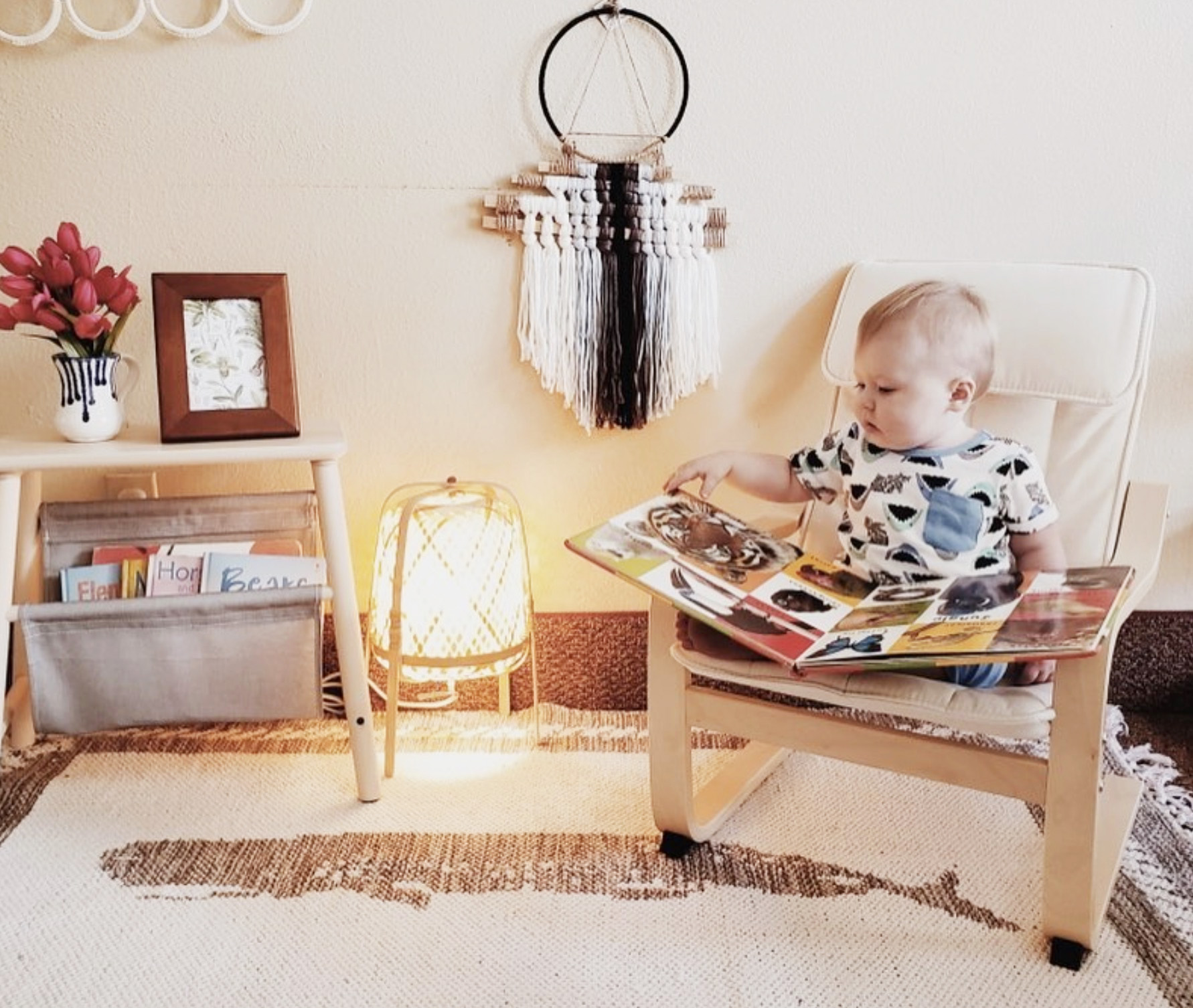 toddler looks at book in cozy room at wild roots