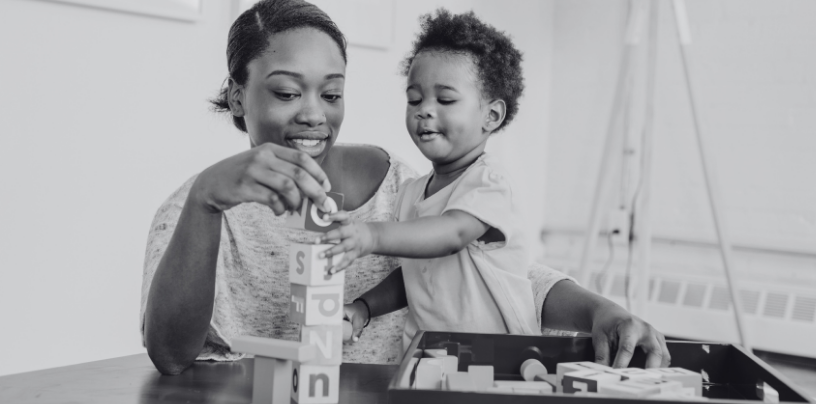 child and parent playing with blocks together